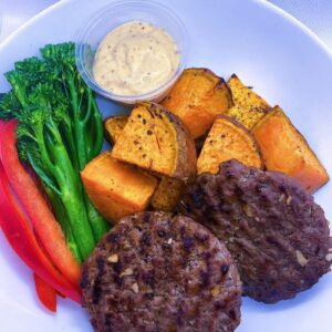 Hand Rolled Beef Burgers, with a side of sweet potatoes, mixed vegetables, and our delicious secret sauce