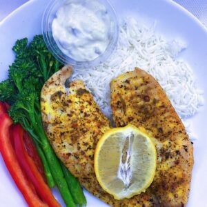 Lemon Pepper Tilapia with a side of basmati rice, broccoli, bell peppers, and a side of tartar sauce