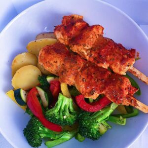 Baked chicken kebabs with roasted potatoes and mixed vegetables