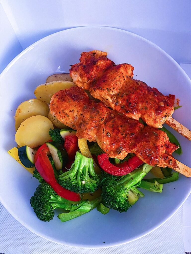 Baked chicken kebabs with roasted potatoes and mixed vegetables