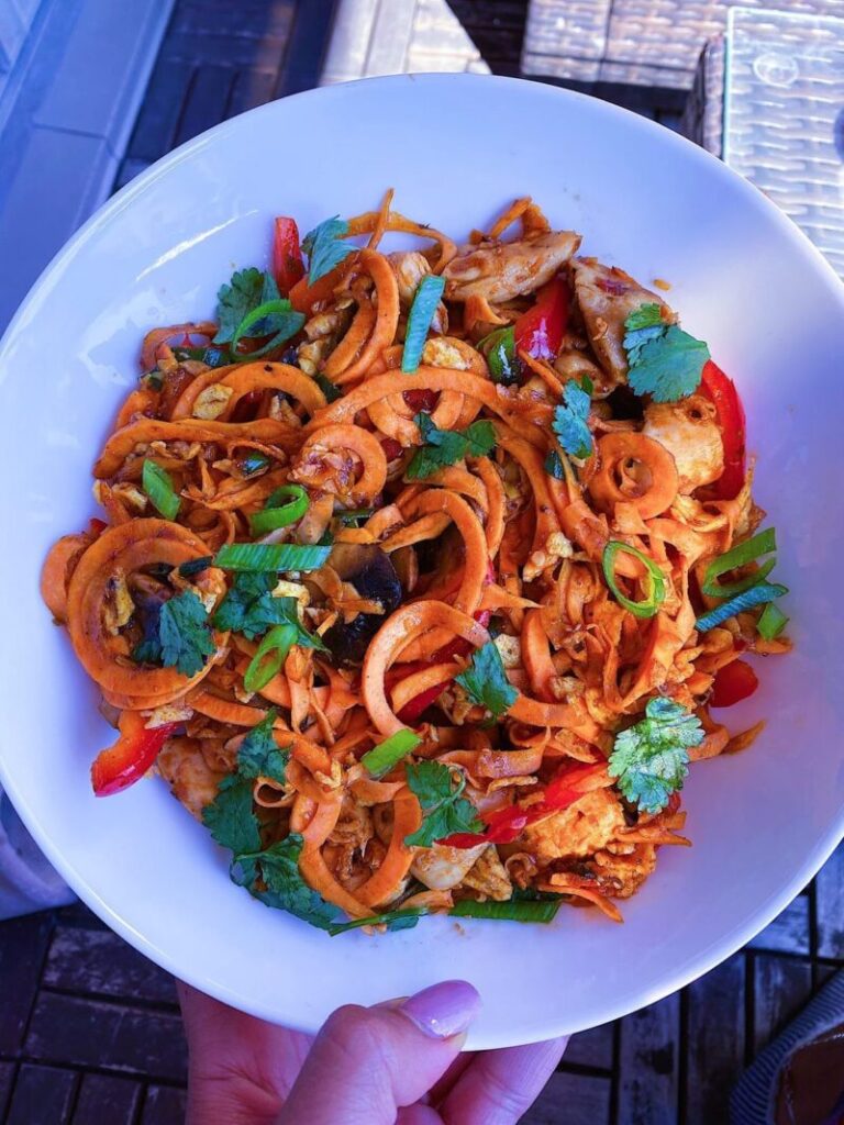 Chicken Pad Thai made with egg noodles, mushrooms, bell peppers, cilantro, and carrots