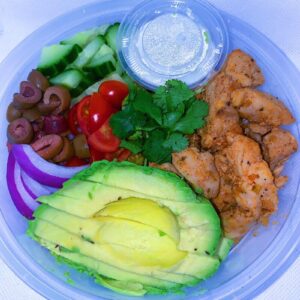 Souvlaki Greek Bowl. Made with basmati rice, olives, tomatoes, onions and cucumbers. Served with a side of tzatziki