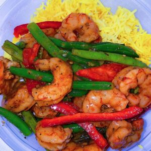 Spicy Honey Lime Shrimp, served with turmeric rice, green beans, and sweet bell peppers