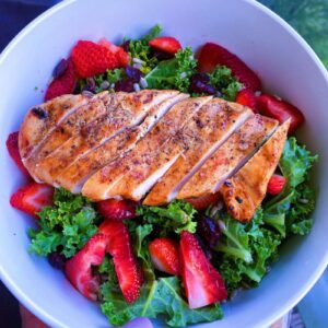 Strawberry, Cranberry and Sunflower Seed Salad. Made with kale, and served with a side of honey citrus dressing