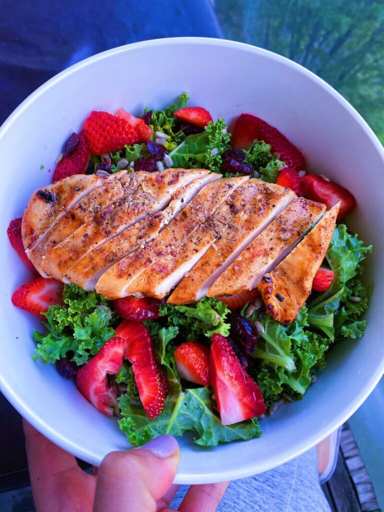 Strawberry, Cranberry and Sunflower Seed Salad. Made with kale, and served with a side of honey citrus dressing